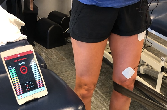 Knee extension with resistance band; sEMG monitor on quadriceps