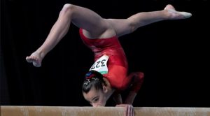 Gymnast inverted on beam